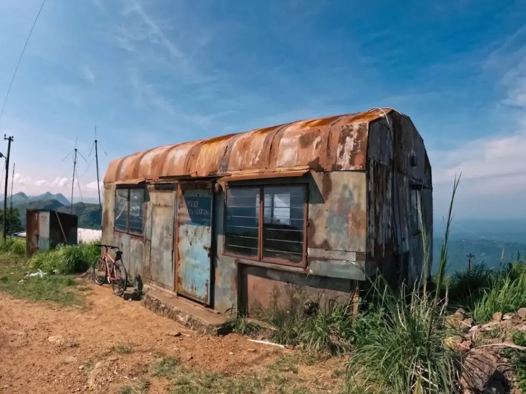 Ilaveezhapoonchira misty landscape at sunrise with rolling green hills and panoramic valley view in Kottayam, Kerala.